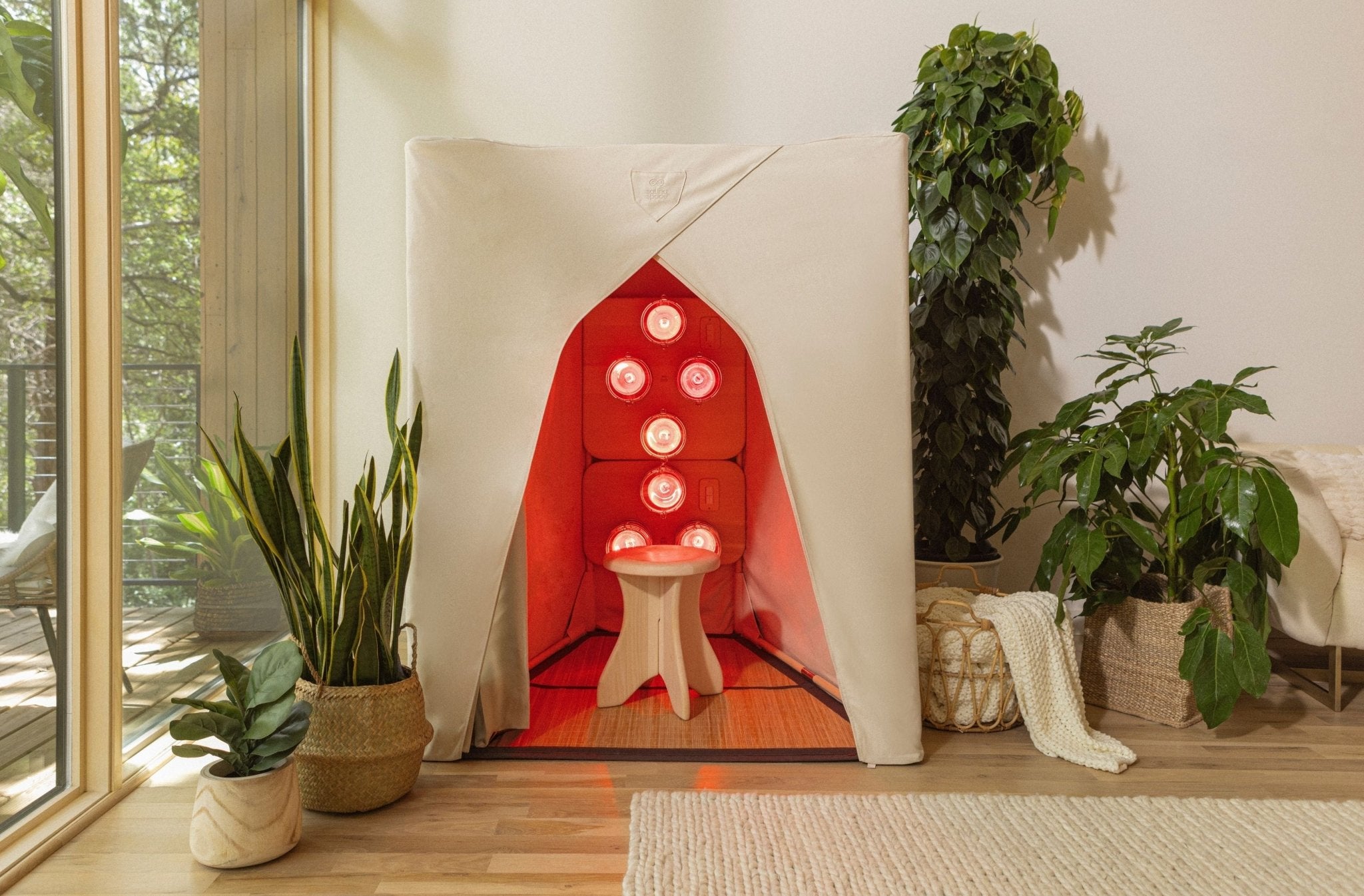 SaunaSpace Firelight sauna with illuminated infrared panels in a bright living room